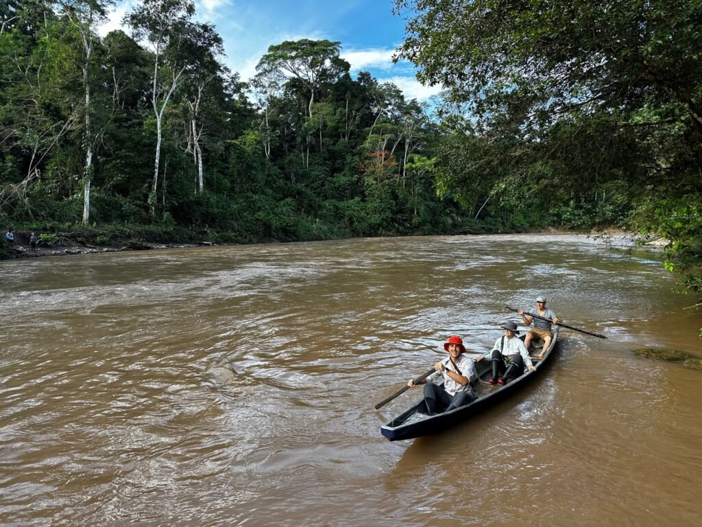 Paddling across a roiling and rapidly rising river with nothing but a 2x4. Corvas is beaming. Adisa is holding on!