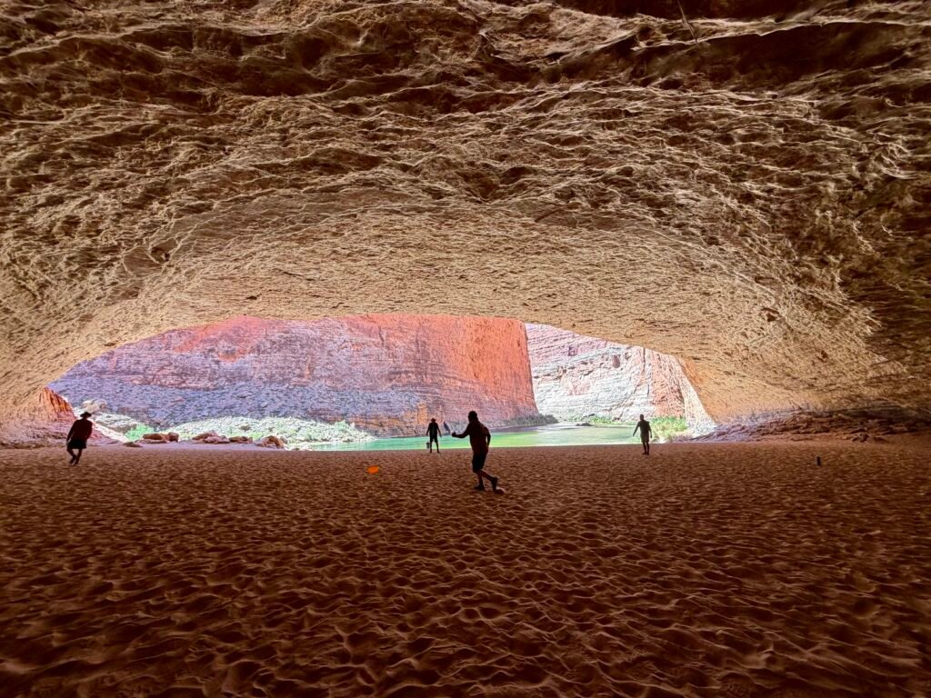 Impromptu frisbee inside a marvelous red wall caves 